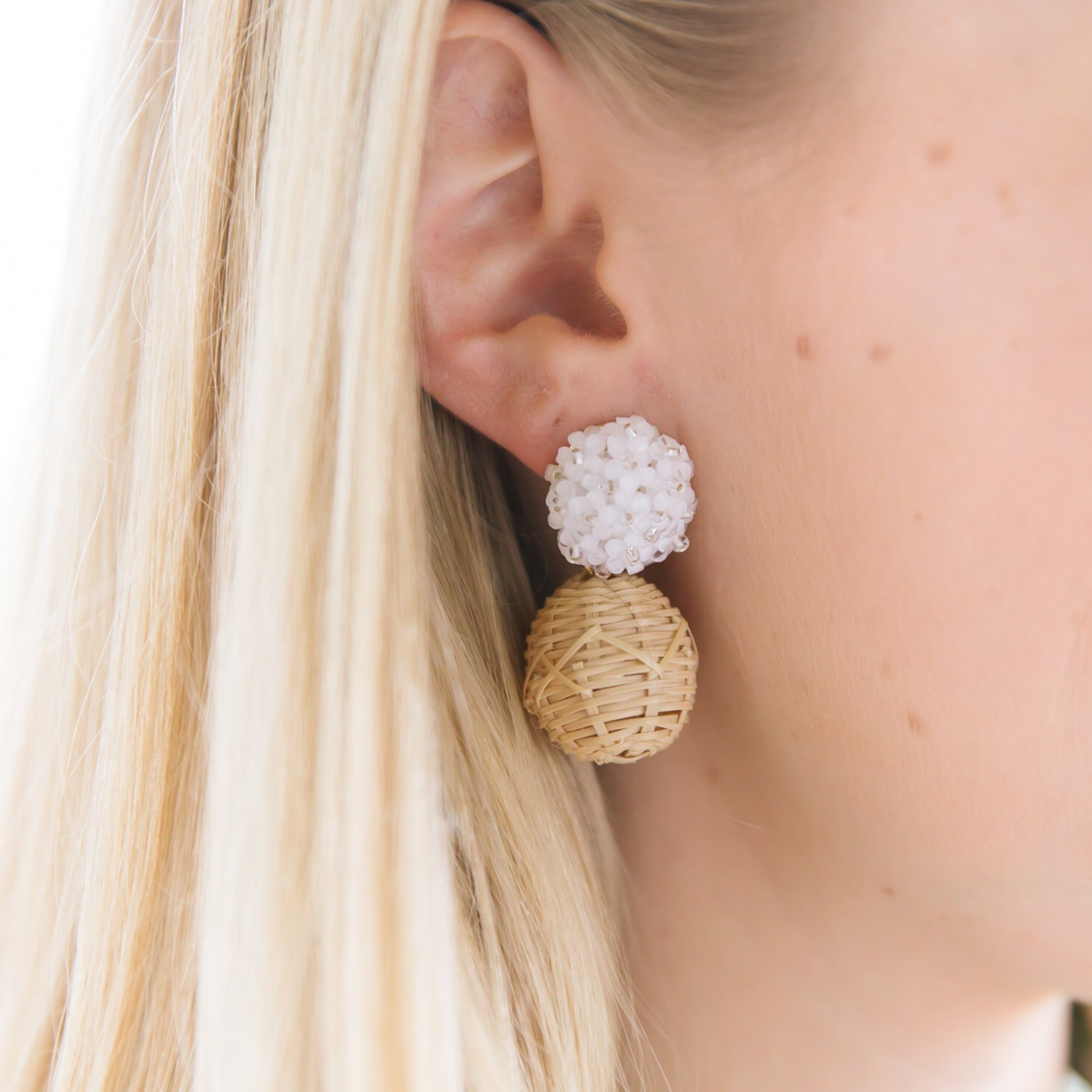 Model is wearing Liz White Rattan Ball Earrings_m donohue collection