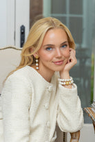 Model wearing Gold Lattice Cotton Pearl Triple Drop Earrings_M Donohue Collection