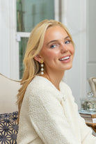Model wearing Gold Lattice Cotton Pearl Triple Drop Earrings_M Donohue Collection