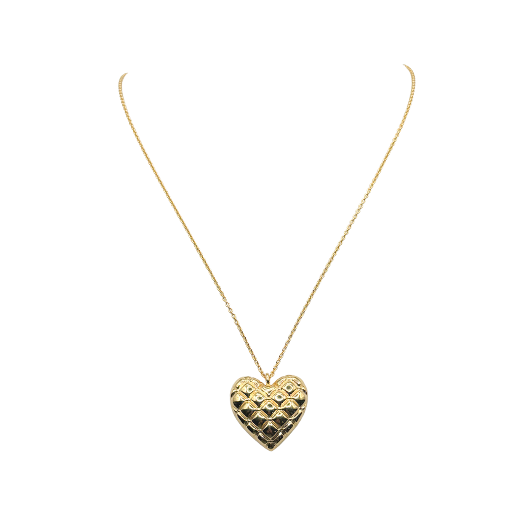 Gold heart-shaped pendant necklace on a white background_m donohue collection