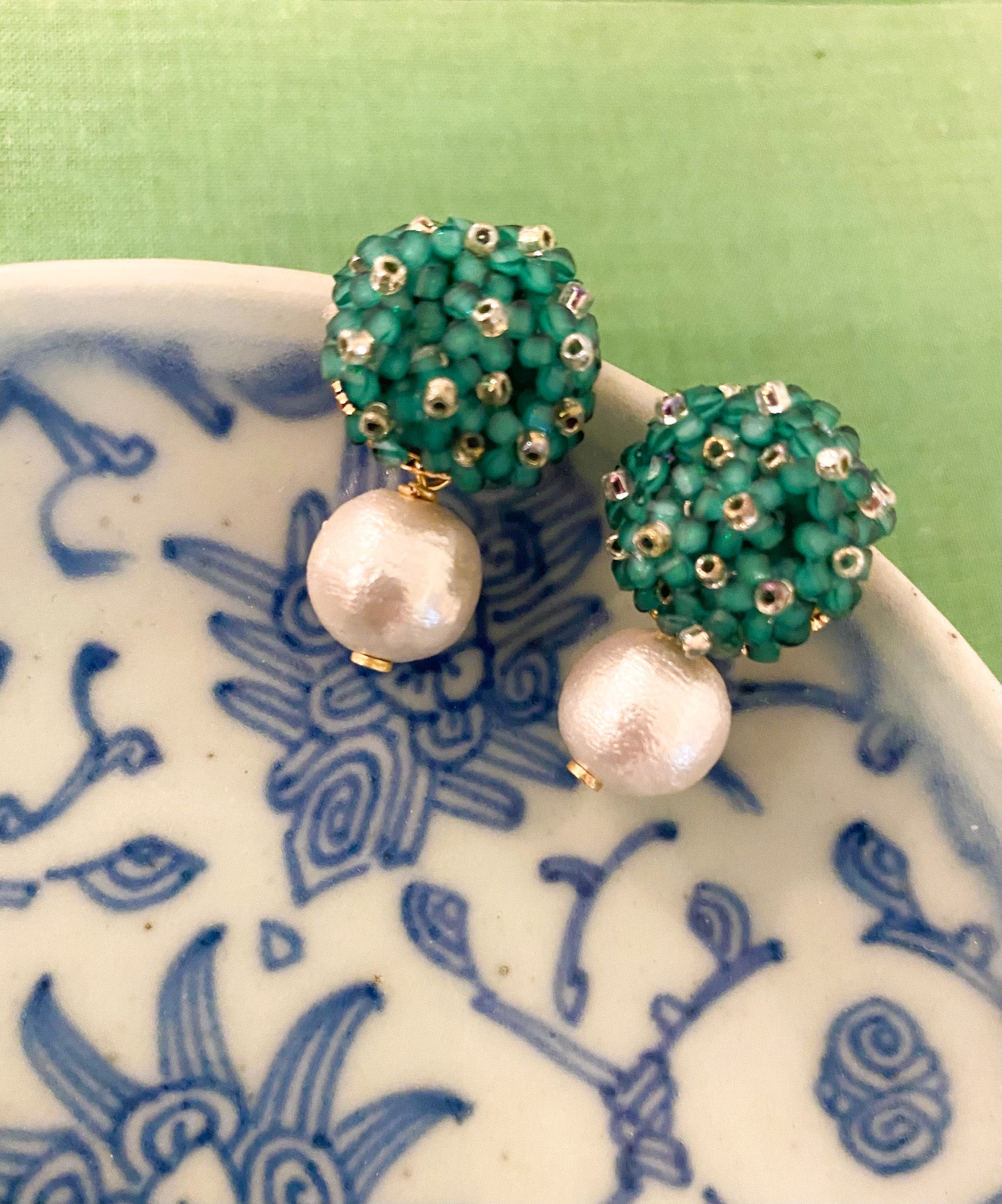 Liz Cotton Pearl Green Earrings displayed on blue porcelain_m donohue collection