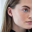 Model is wearing Tiny Bloom Gold Stud Earrings_m donohue collection