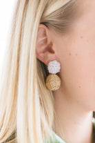 Model is wearing Liz White Rattan Ball Earrings_m donohue collection