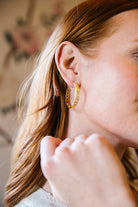 Model is wearing Versailles Treillage Gold Hoop Earrings_m donohue collection