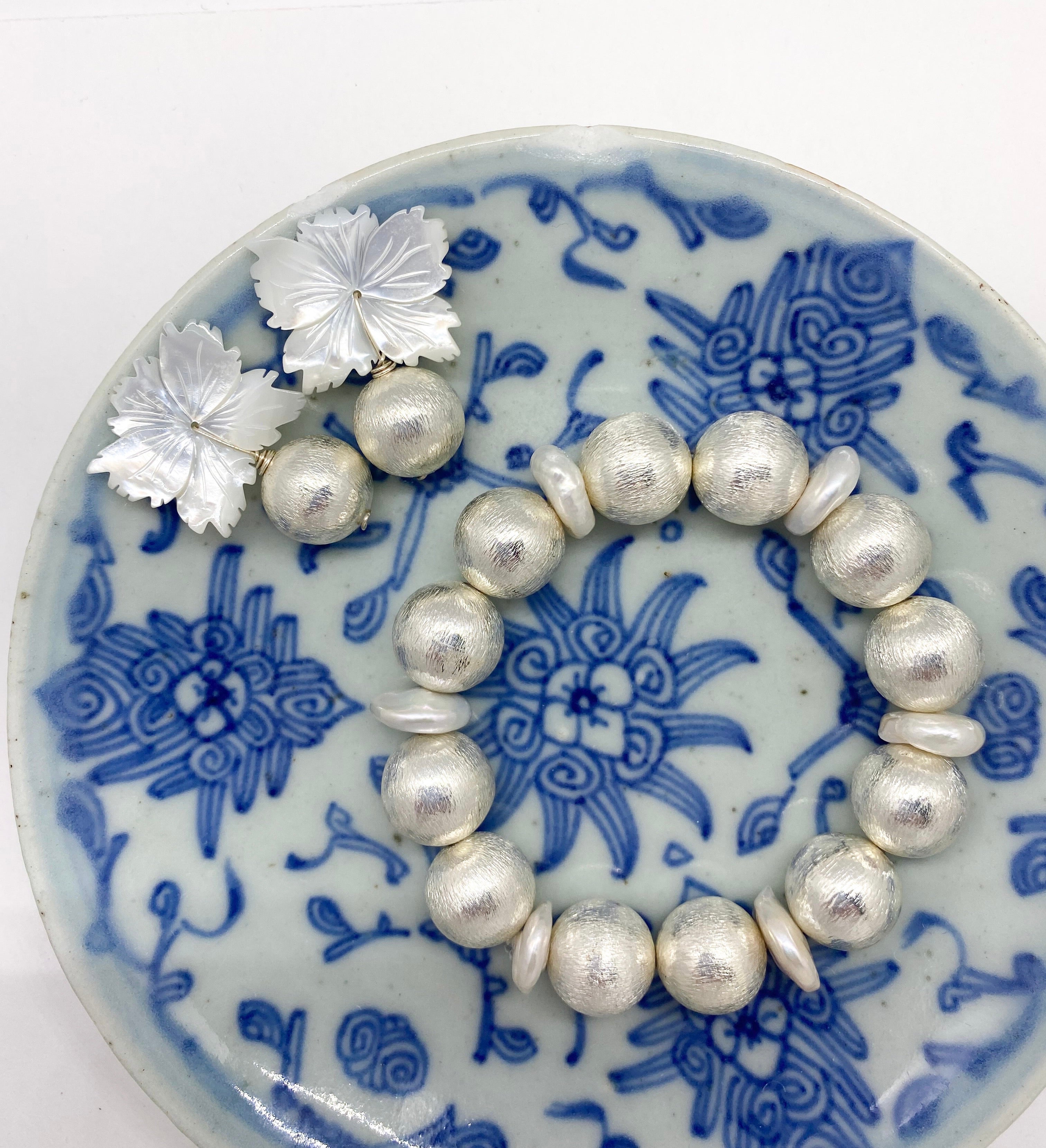 Pamela Silver & Pearl displayed with Audrey Silver Earrings on blue porcelain dish_m donohue collection